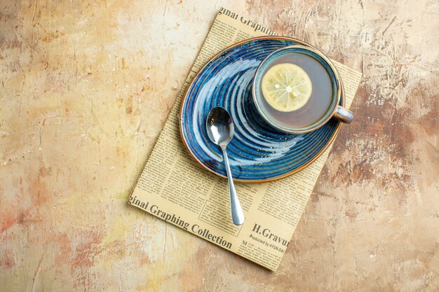 Top view cup of tea with lemon slice on light background