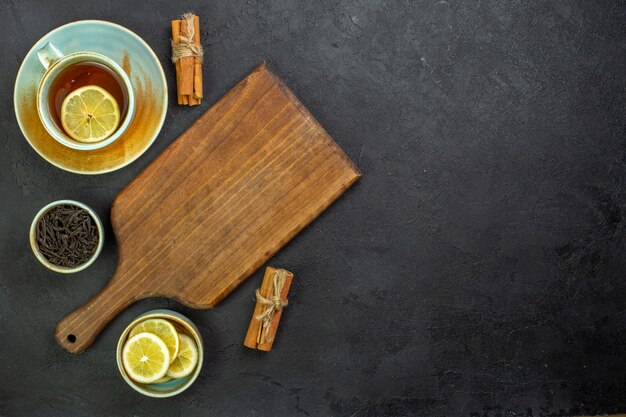 Top view cup of tea with lemon slices and cinnamon