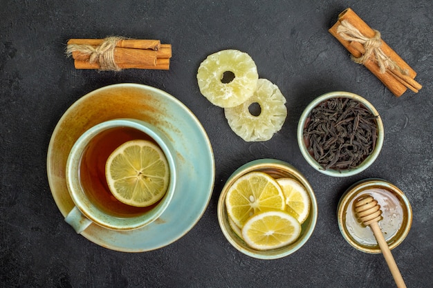 Top view cup of tea with lemon slices and honey