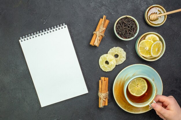 Top view cup of tea with lemon slices and honey