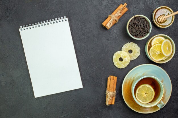 Top view cup of tea with lemon slices and honey