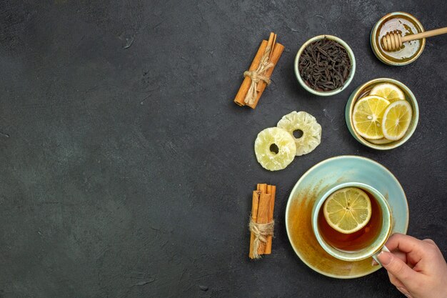 Top view cup of tea with lemon slices and honey