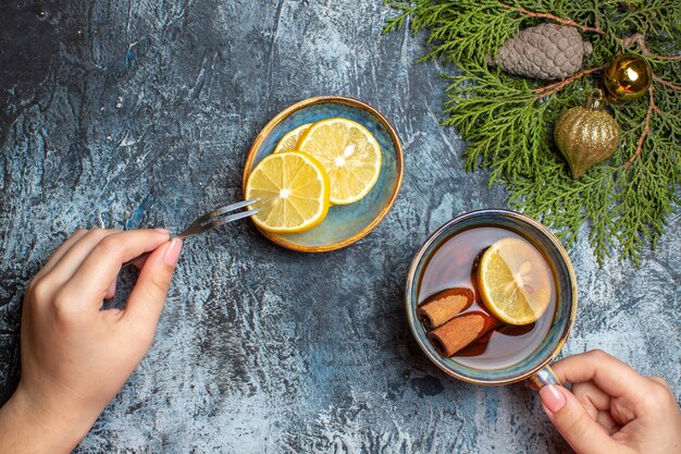 Top view cup of tea with lemon slices on light background