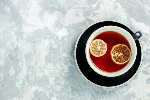 Top view cup of tea with lemon slices on the white background tea drink flowers lemon