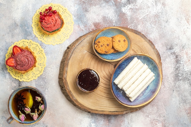 Top view cup of tea with little cakes