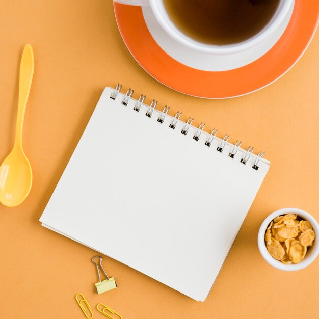 Top view cup of tea with notebook