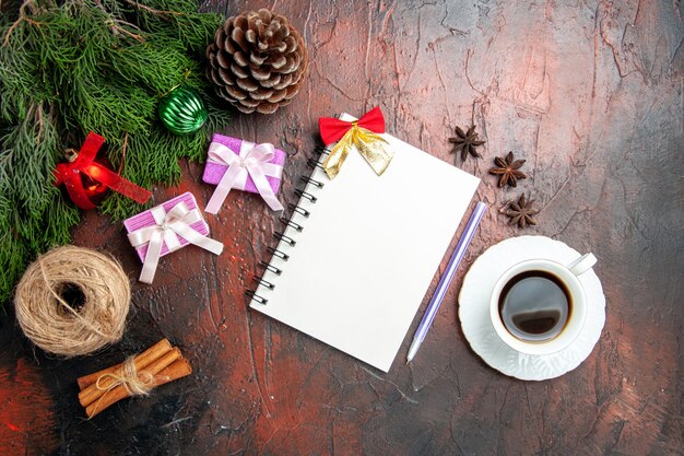 Top view cup of tea with notepad and cones