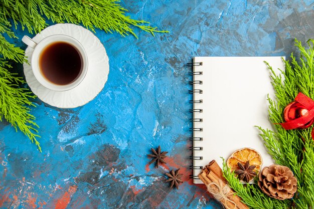 Top view cup of tea with notepad