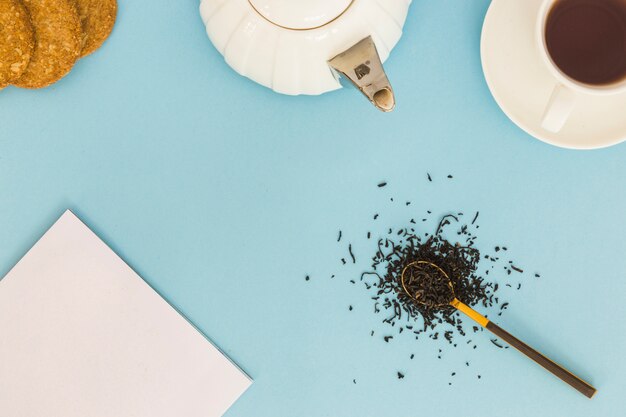 Top view cup of tea with spoon full of dry leaves