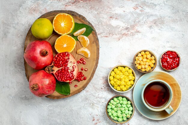 Top view cup of tea with sugar candies on white desk