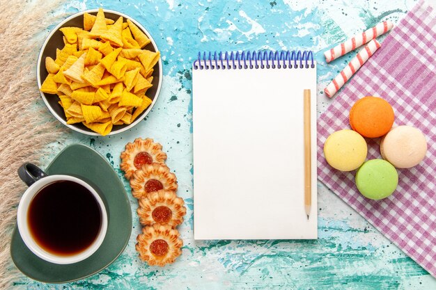 Top view cup of tea with sugar cookies and chips on light blue background cookie biscuit sugar sweet tea cake pie