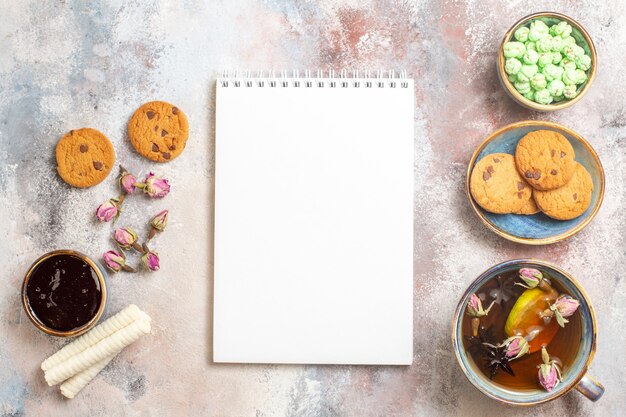 Top view cup of tea with sweets