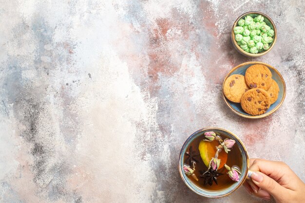 Top view cup of tea with sweets