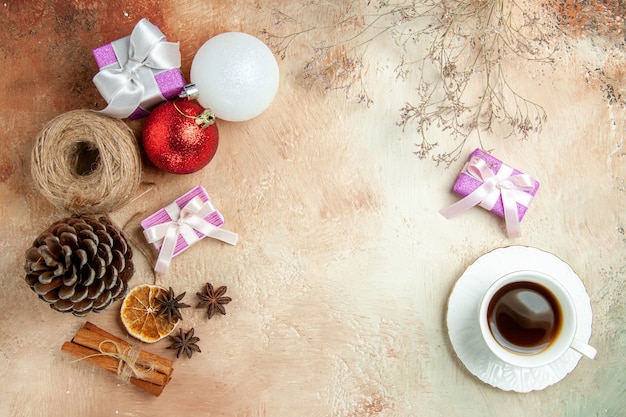 Top view cup of tea with toys and presents