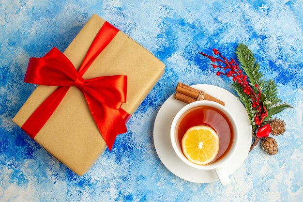 Top view cup of tea xmas gift on blue table