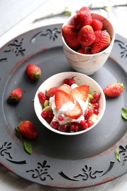 Top view cup with ice cream with berries and strawberries