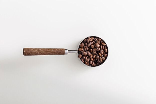 Top view of cup with roasted coffee beans