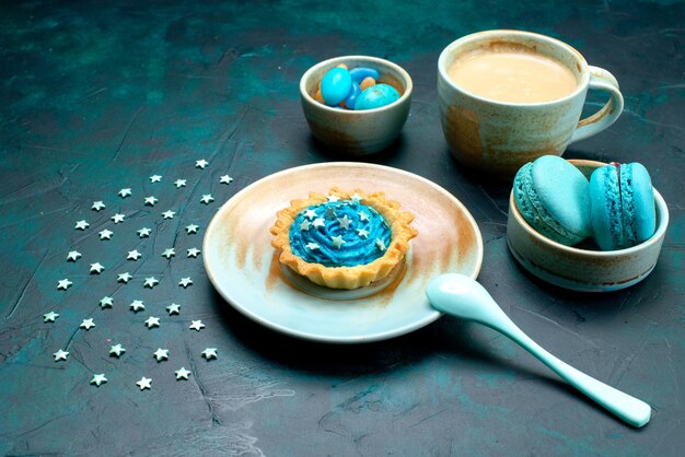 Top view of cupcake with stars next to dessert spoon and delicious coffee