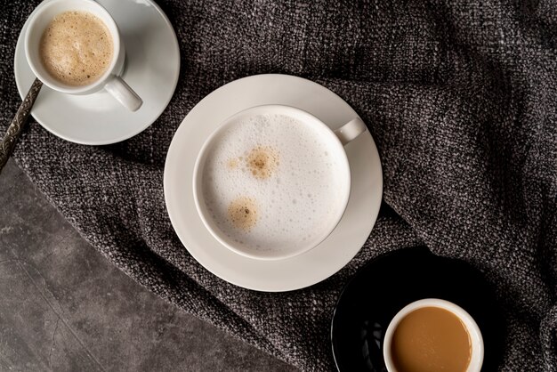 Top view cups of coffee on fabric