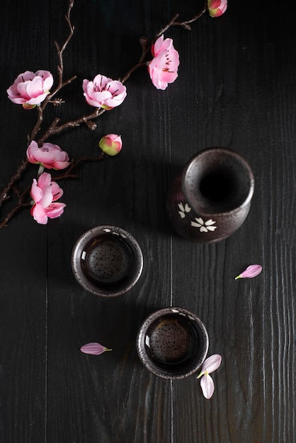 Top view cups and pink flowers arrangement