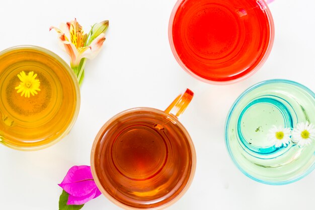 Top view cups of tea with flowers