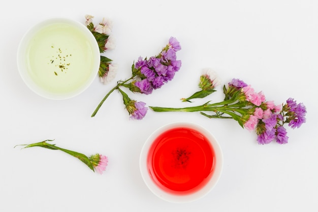 Top view cups of tea with flowers