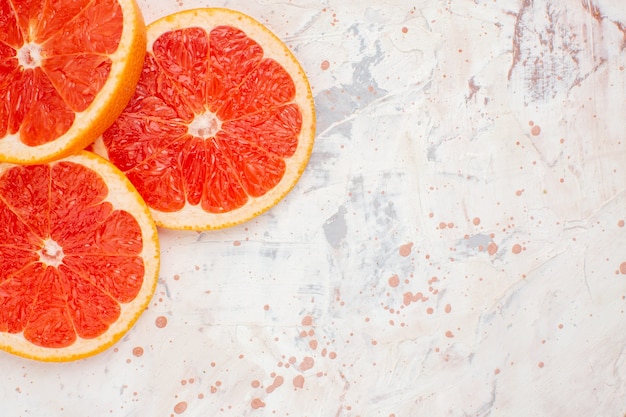 Top view cut grapefruits on nude surface free space