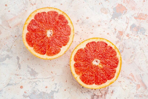 Top view cut grapefruits on nude surface