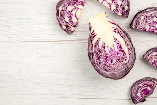 Top view cut red cabbages on wooden surface copy space