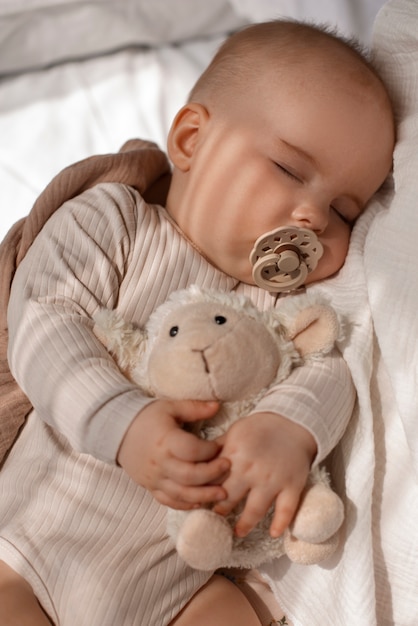 Top view cute baby with stuffed animal