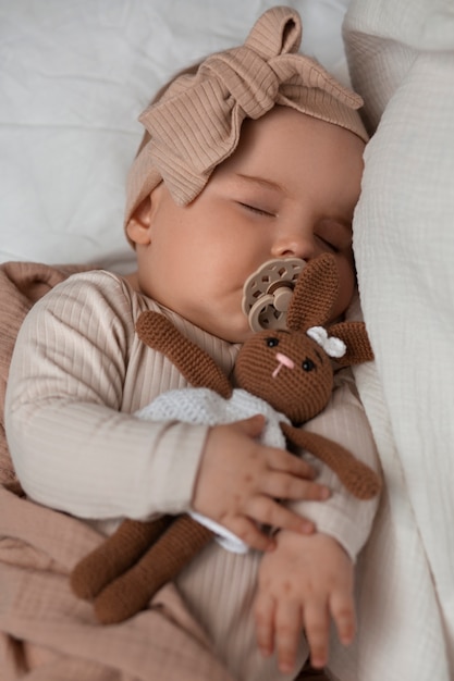 Top view cute baby with stuffed animal