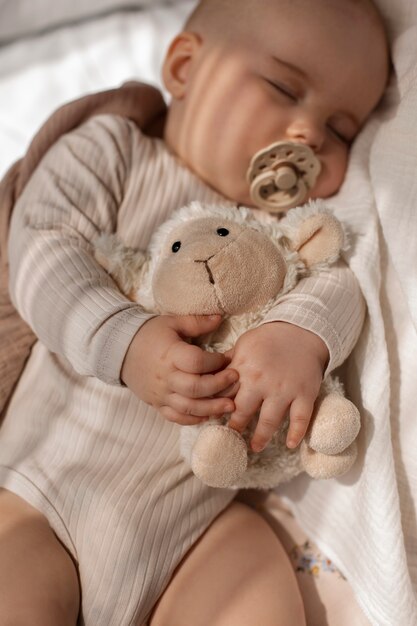 Top view cute baby with stuffed animal