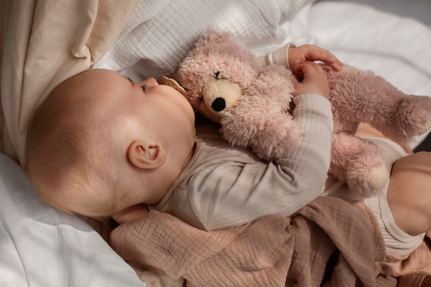 Top view cute baby with stuffed animal