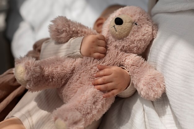 Top view cute baby with stuffed animal