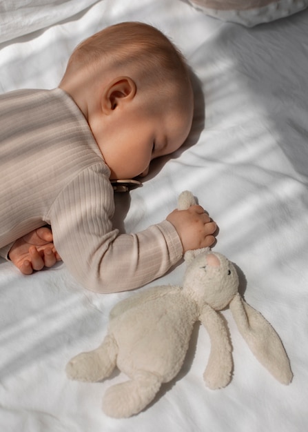 top view cute baby with stuffed animal