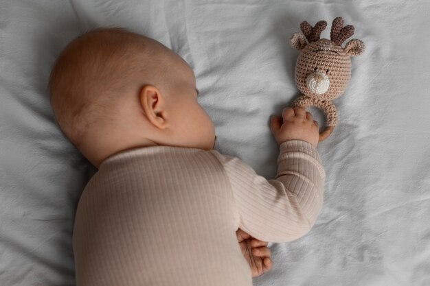 Top view cute baby with stuffed animal