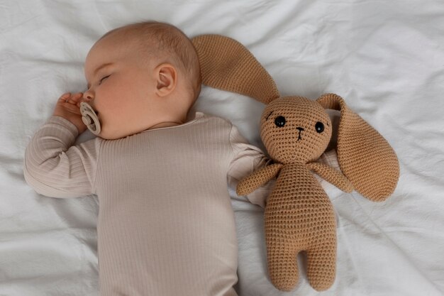 Top view cute baby with stuffed animal