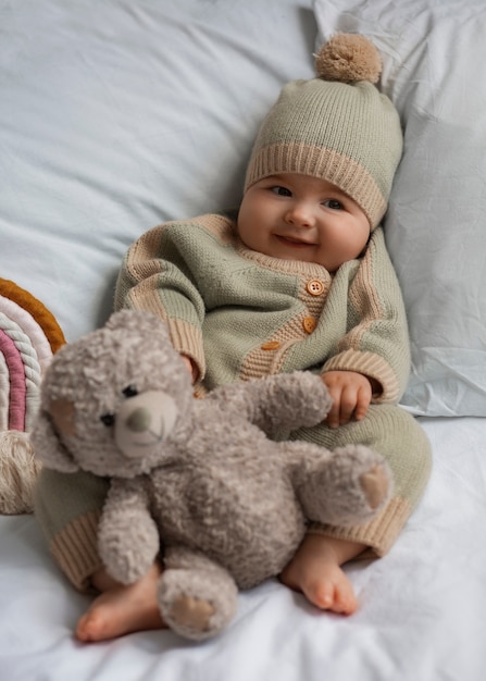 Top view cute baby with stuffed animal