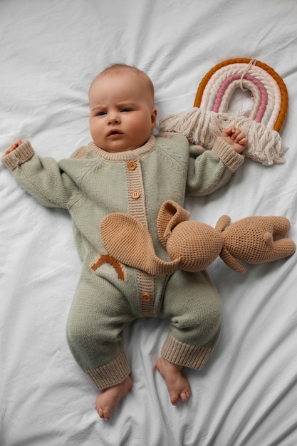 Top view cute baby with stuffed animal