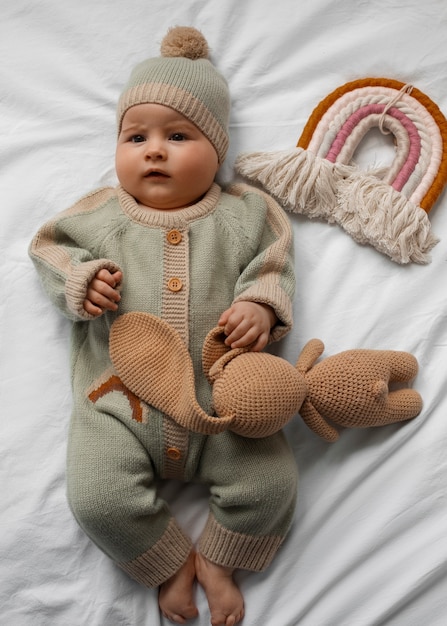 Top view cute baby with stuffed animal