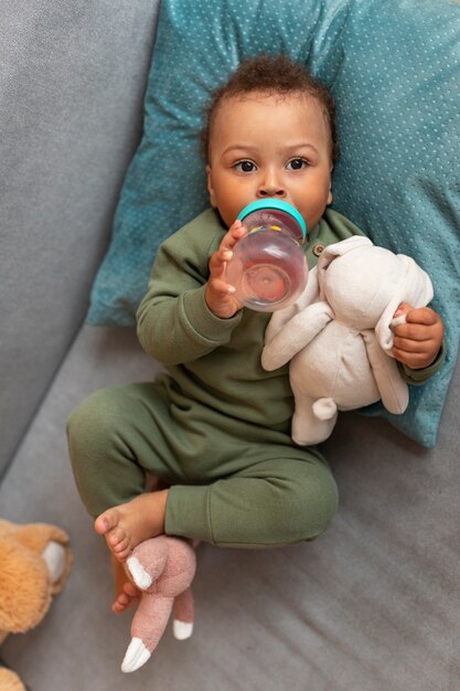 Top view cute baby with stuffed animal