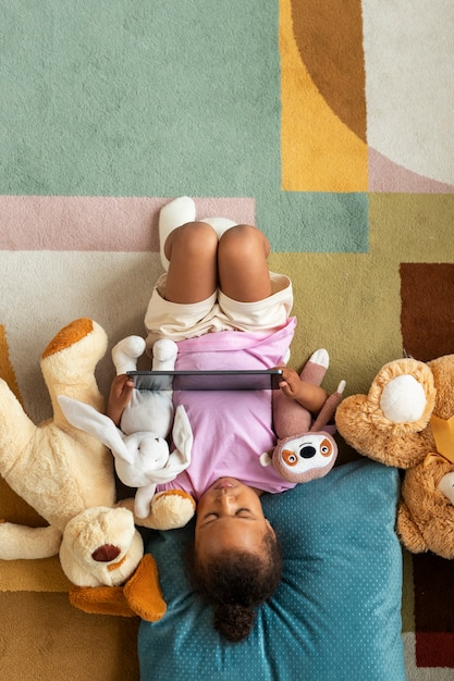 Top view cute baby with stuffed animal