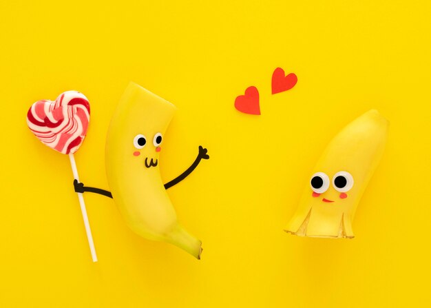 Top view cute bananas with lollipop