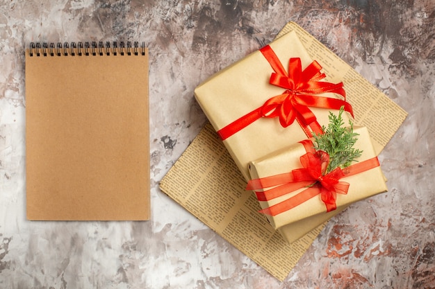 Free photo top view cute christmas present tied with red bow on light background