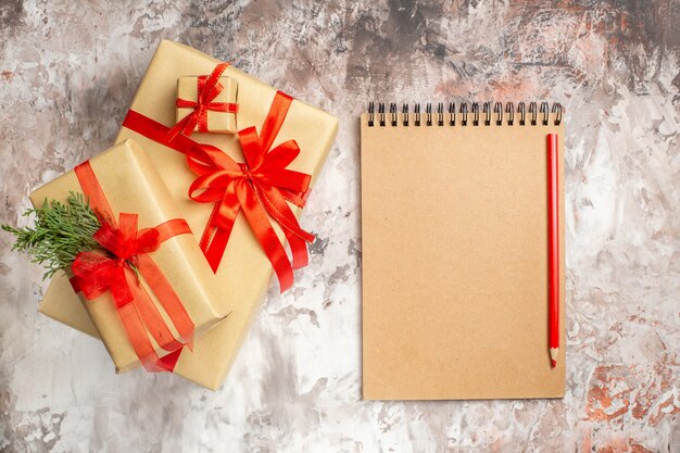 Top view cute christmas presents tied with red bows on light background