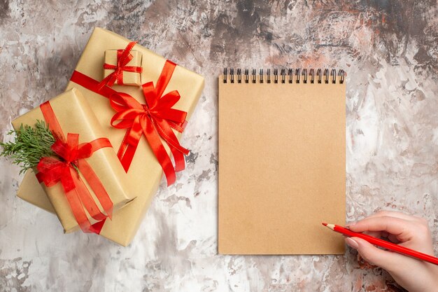 Top view cute christmas presents tied with red bows on light background