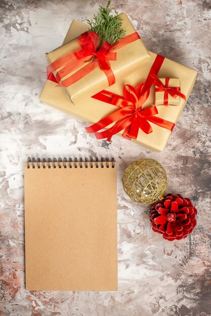 Top view cute christmas presents tied with red bows on light background