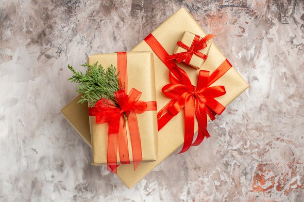 Top view cute christmas presents tied with red bows on the light background