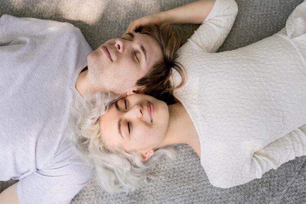 Top view of cute couple relaxing outdoors on a blanket