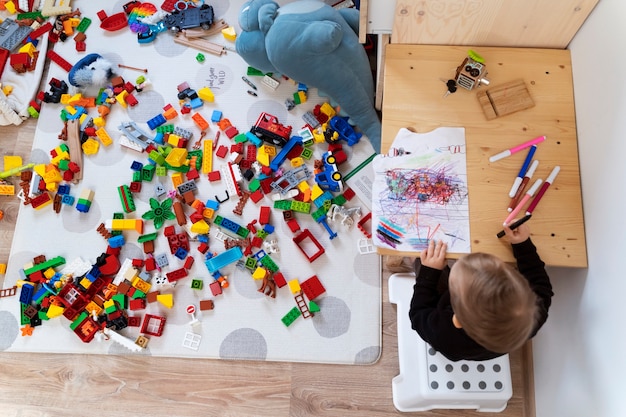 Top view cute kid drawing at table